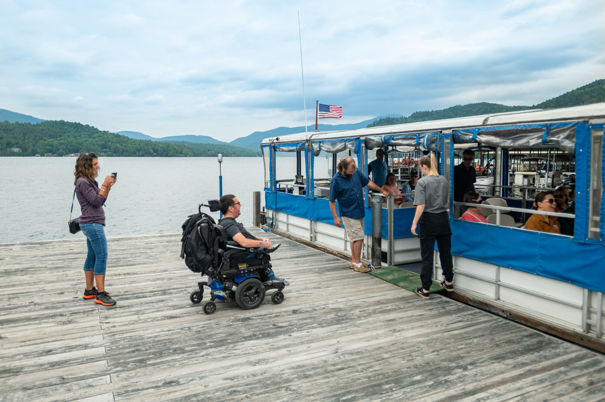 A man in a wheelchair heads onto a tour boat on Lake Placid