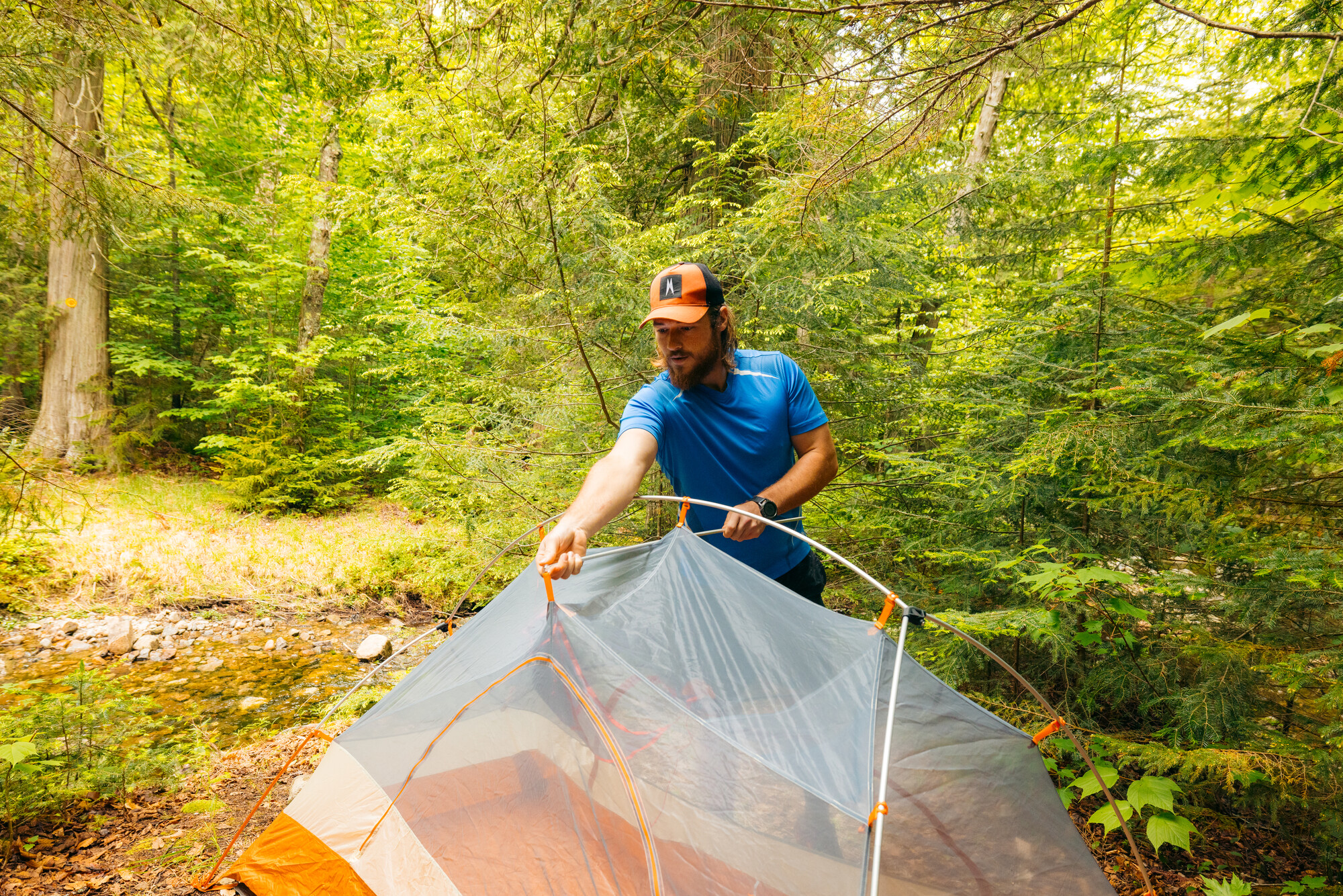 A hiker setting up his tent