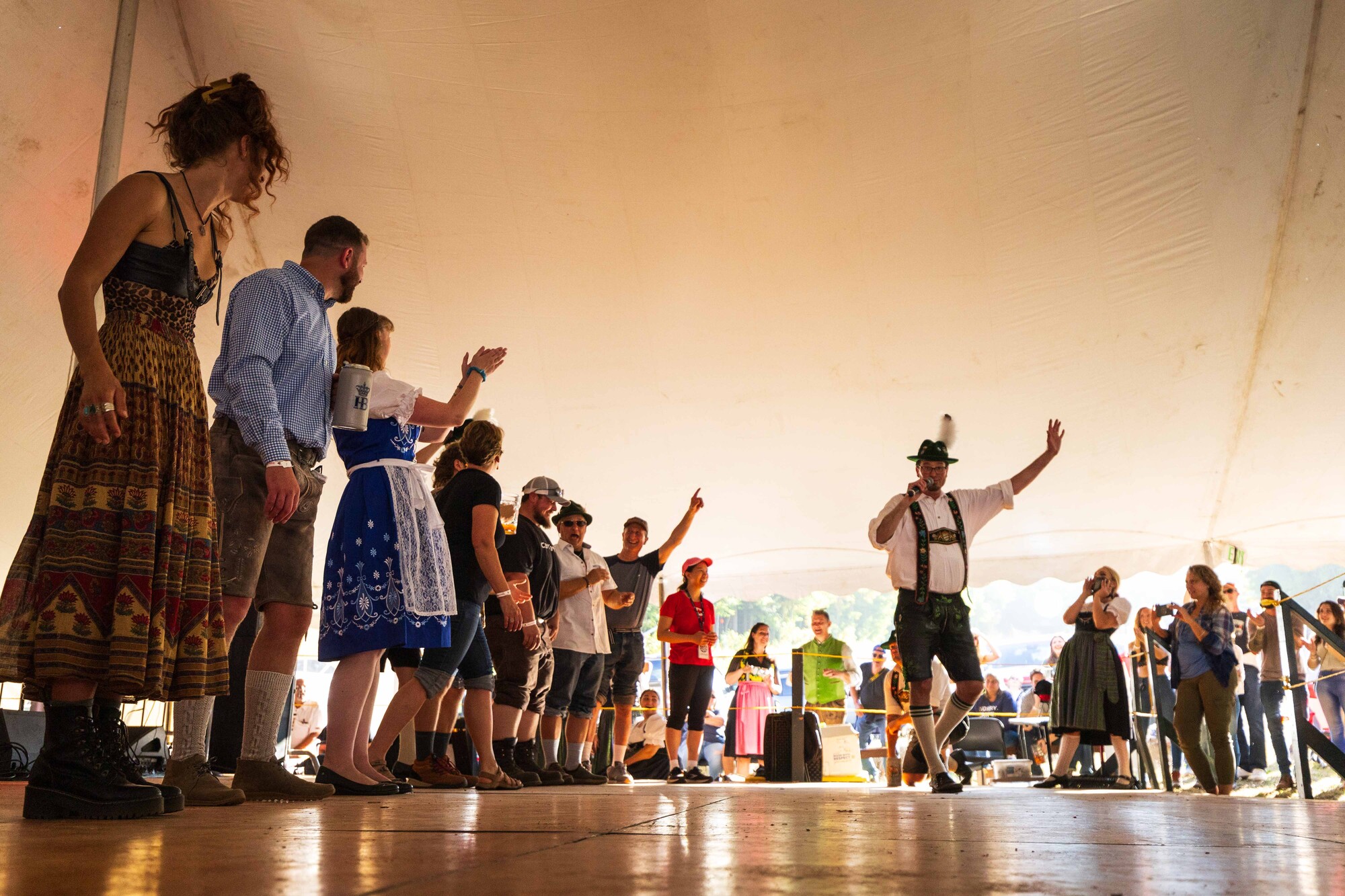 People dancing at Oktoberfest under a tent