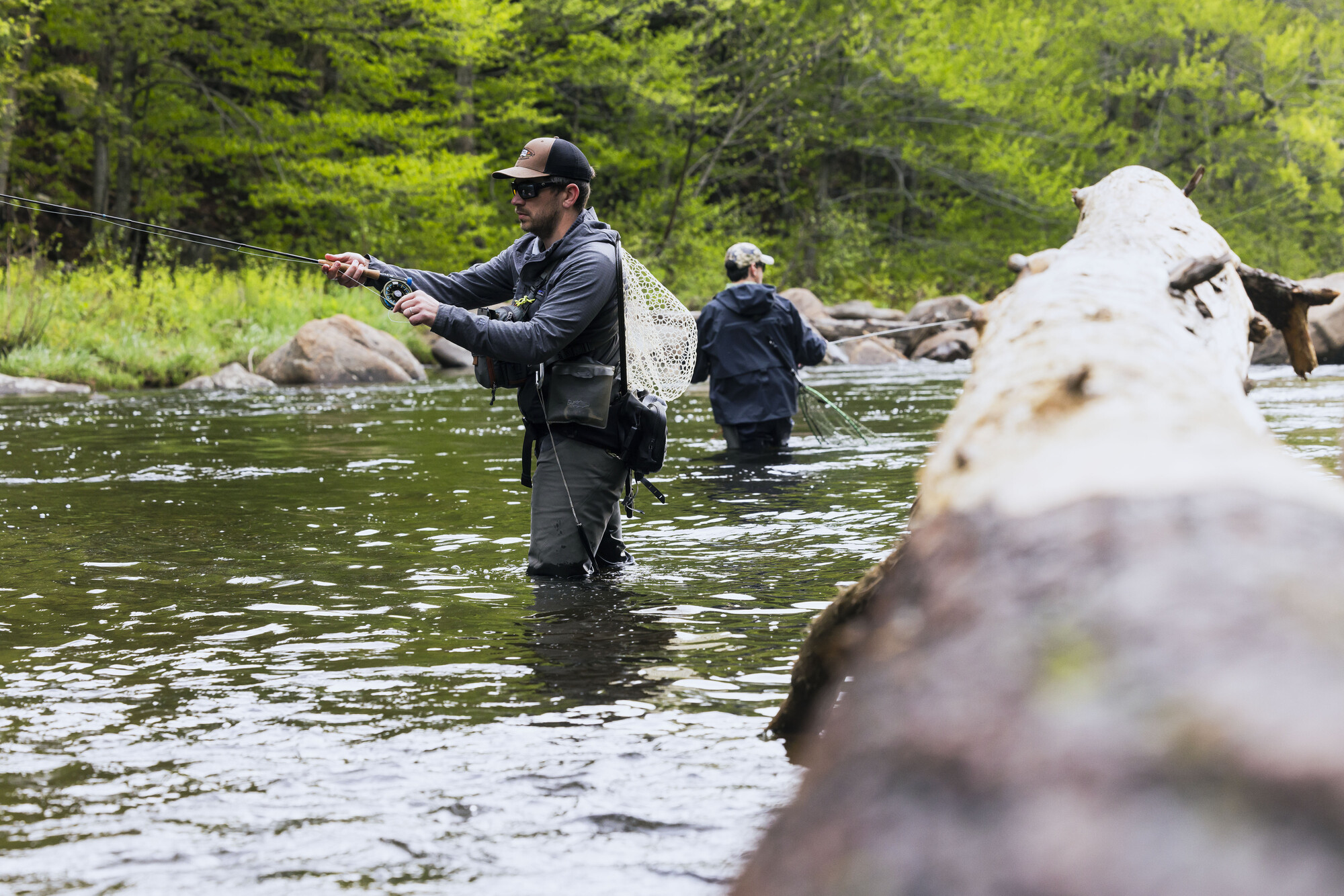 Two people fly fishing in the river