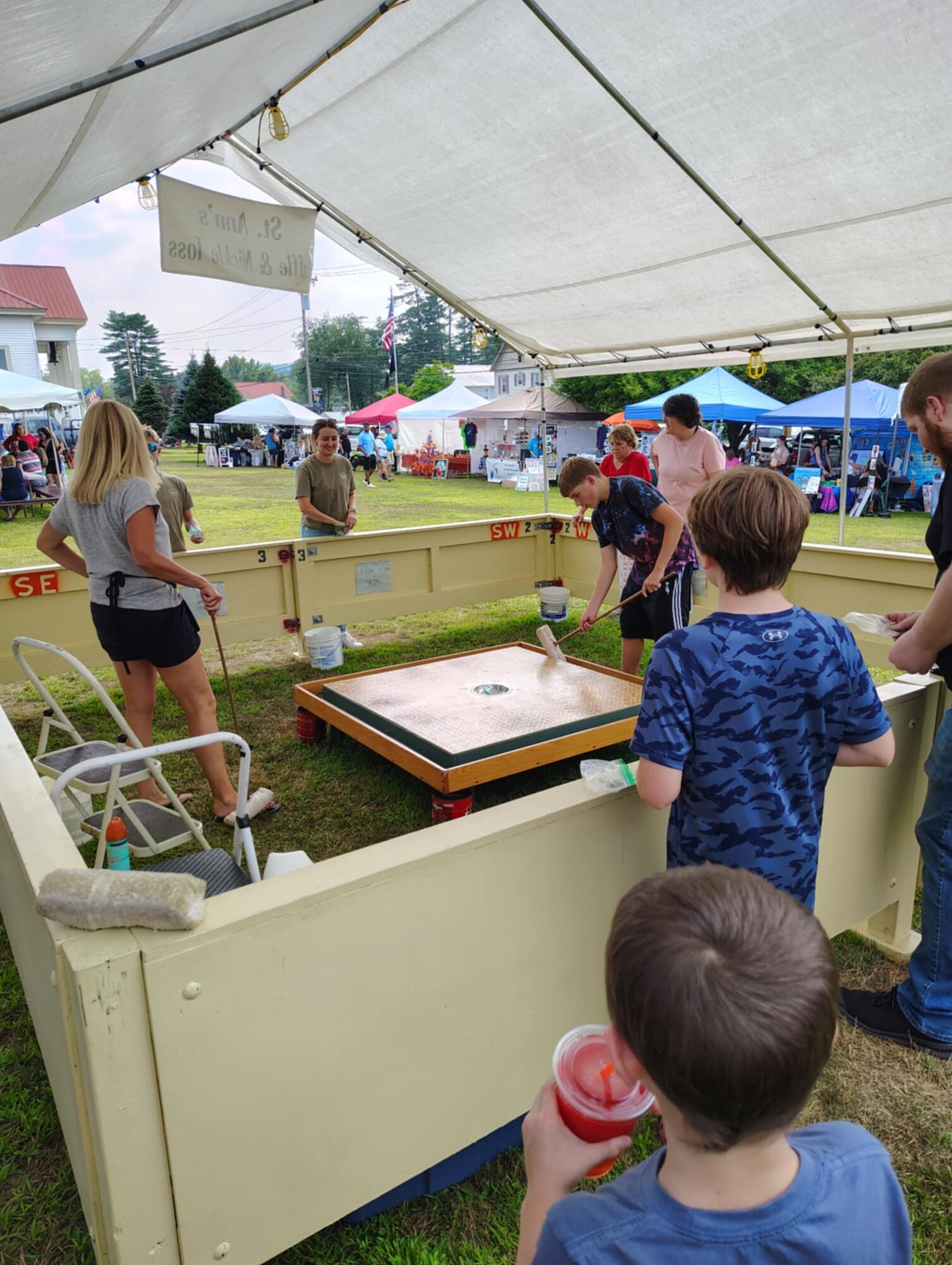 People playing a game at a festival outdoors