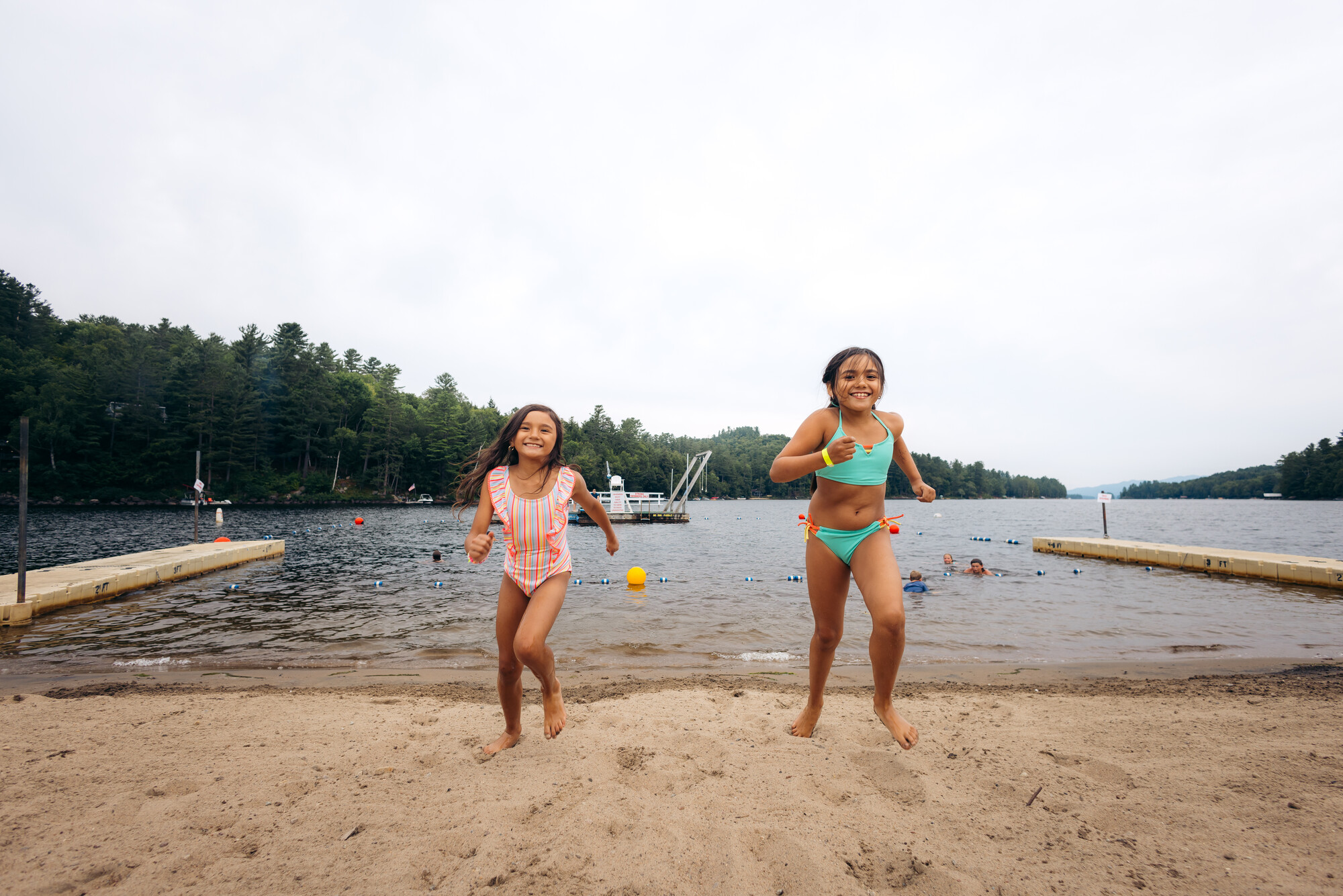 Two kids running at a beach