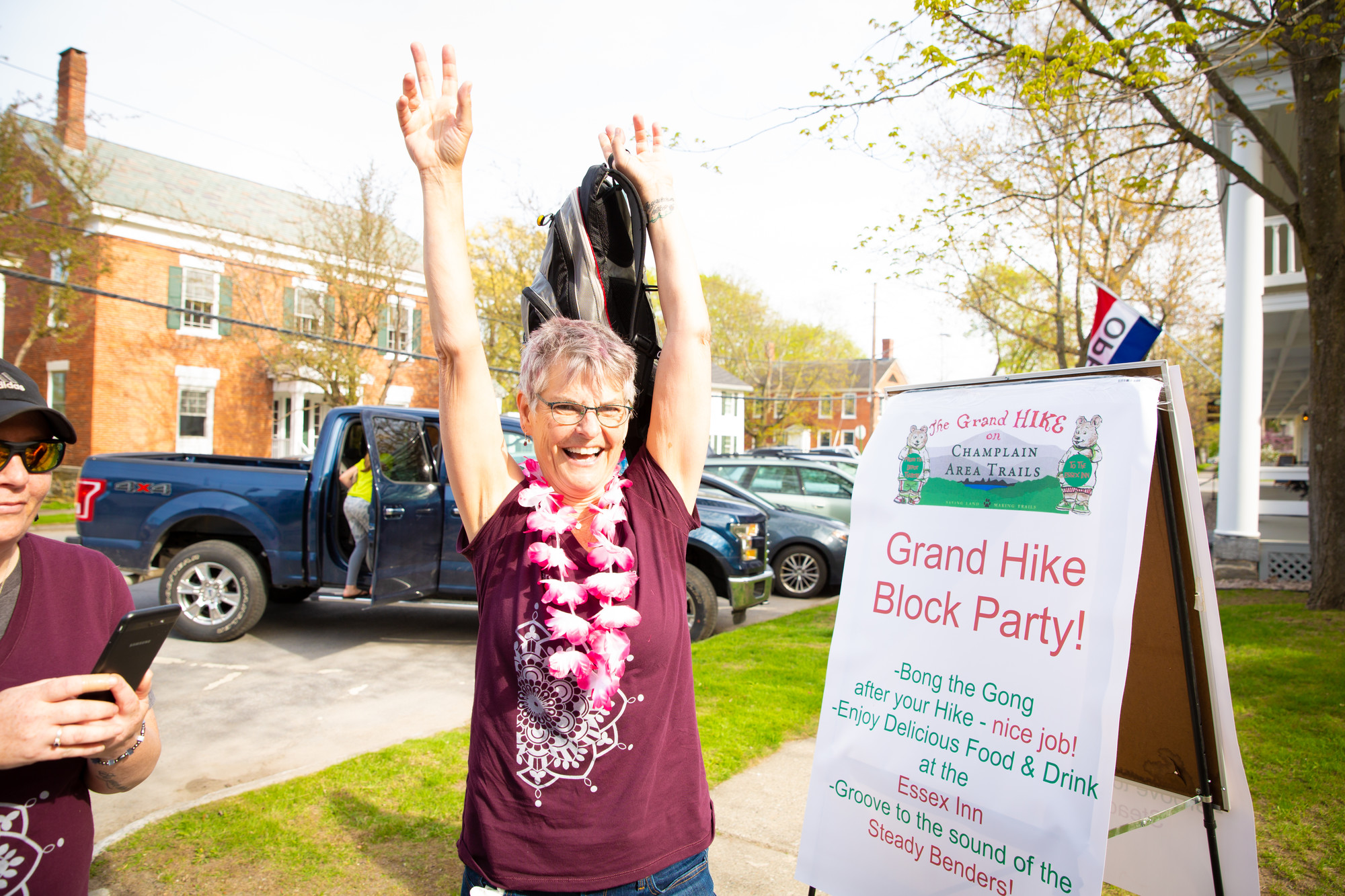 A woman celebrating the Grand Hike block party