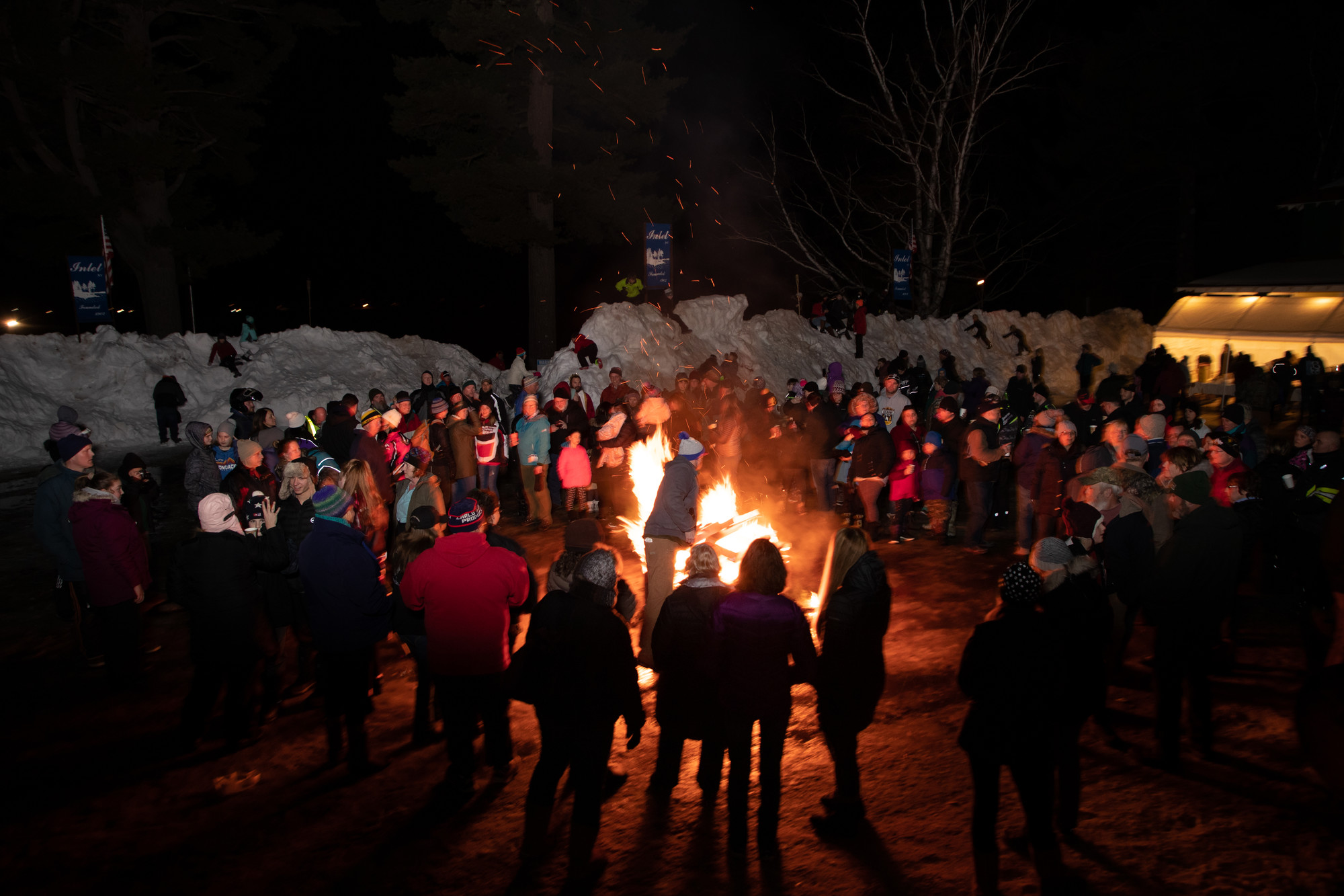 People surrounding a bonfire