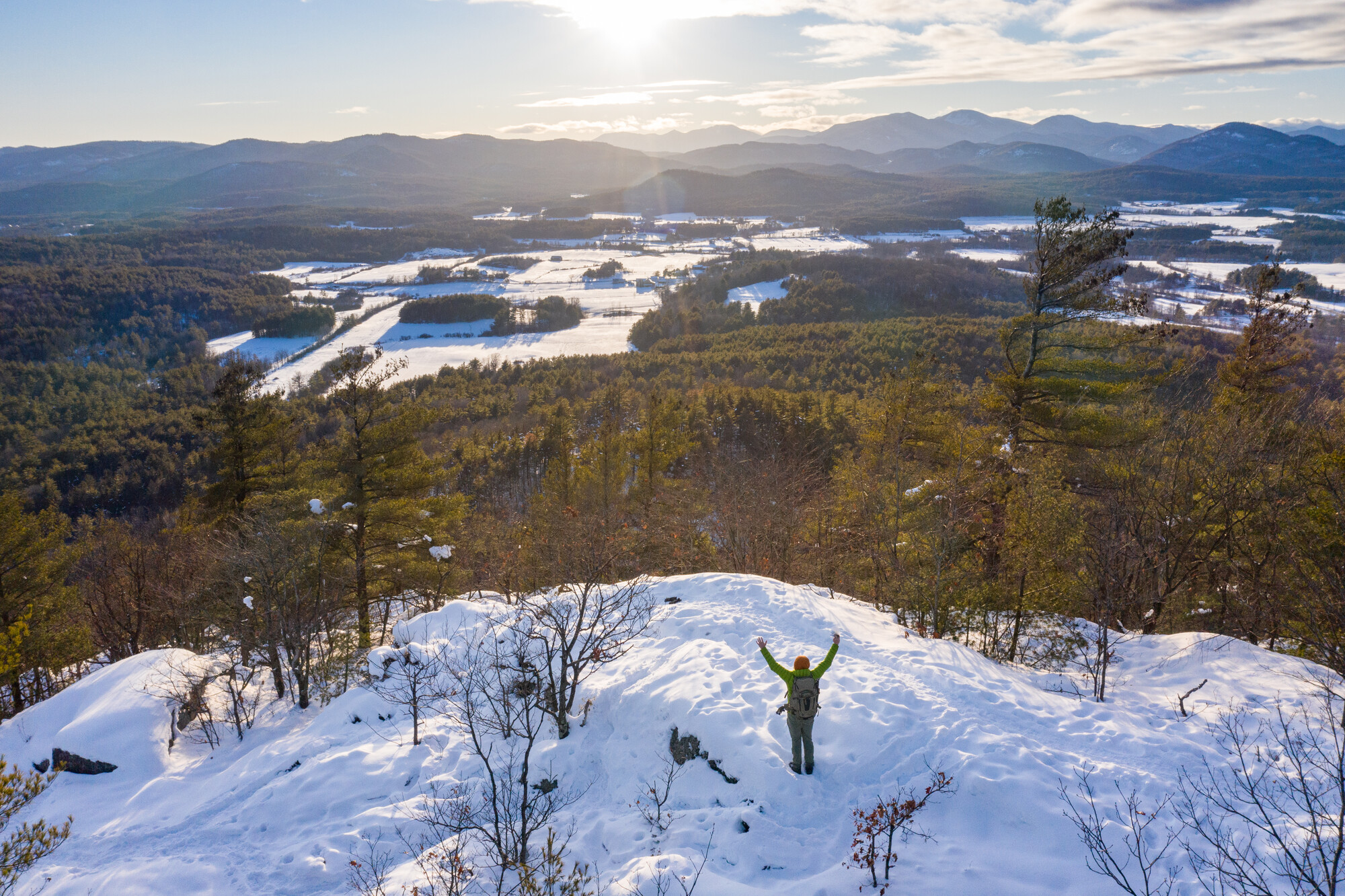 A snowshoer on top of a summit