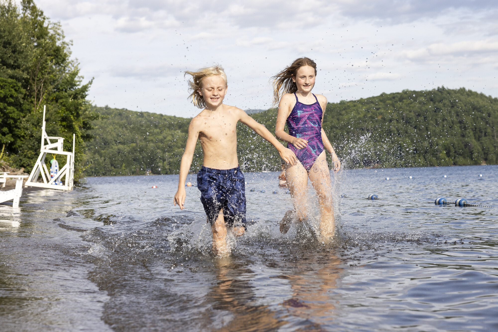 Two kids running at the beach
