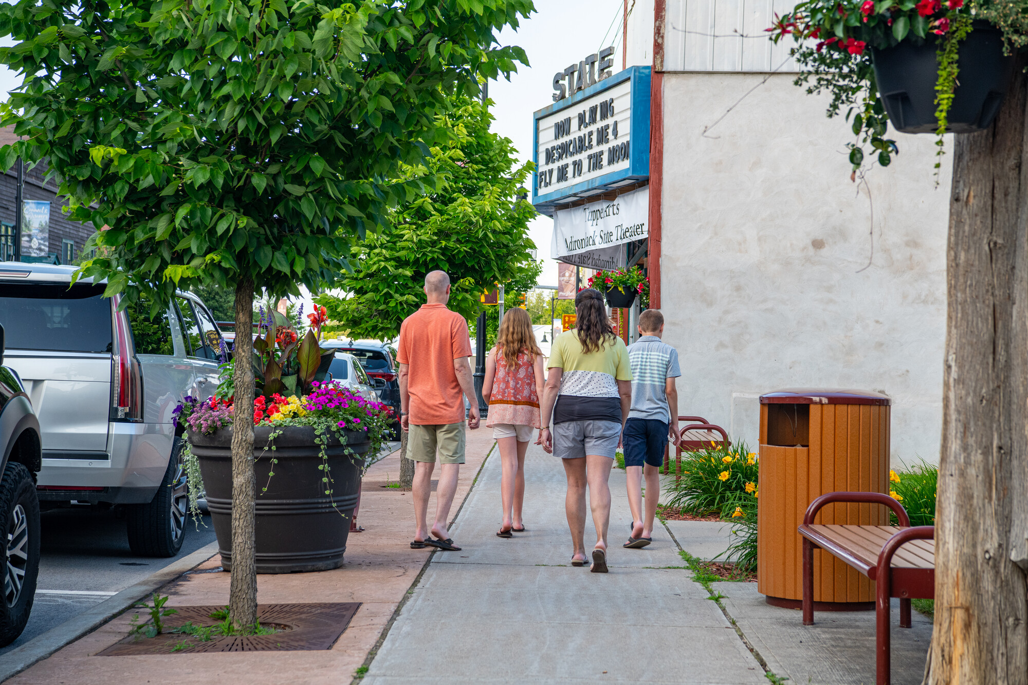 A family walking in front of a movie theater