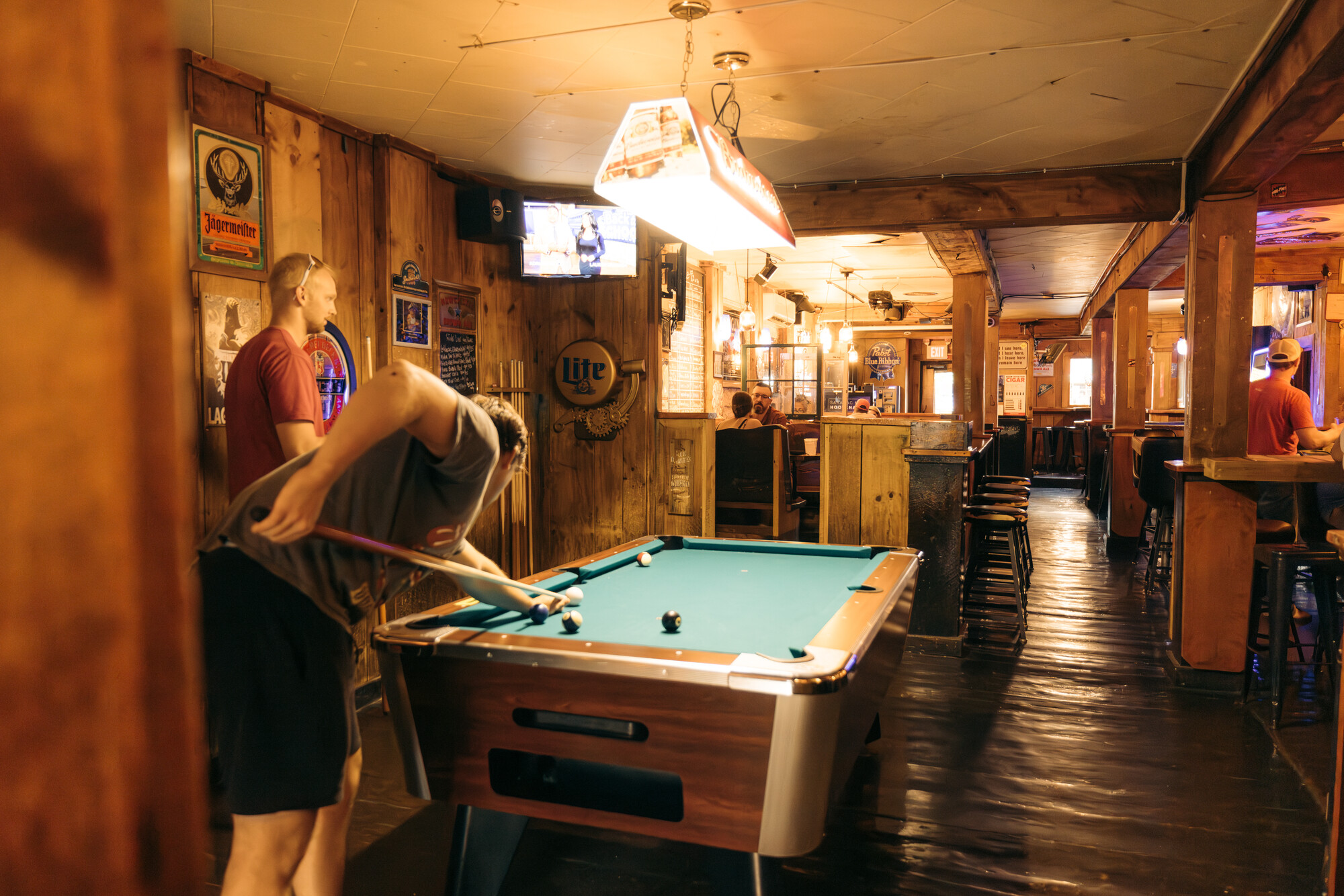 Someone shooting pool at Grizle T's