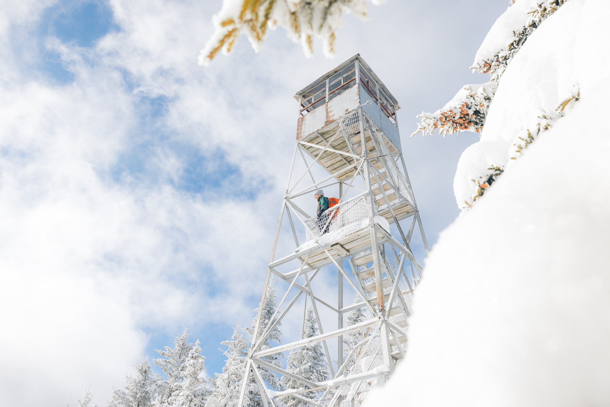 A snowshoer on a winter fire tower