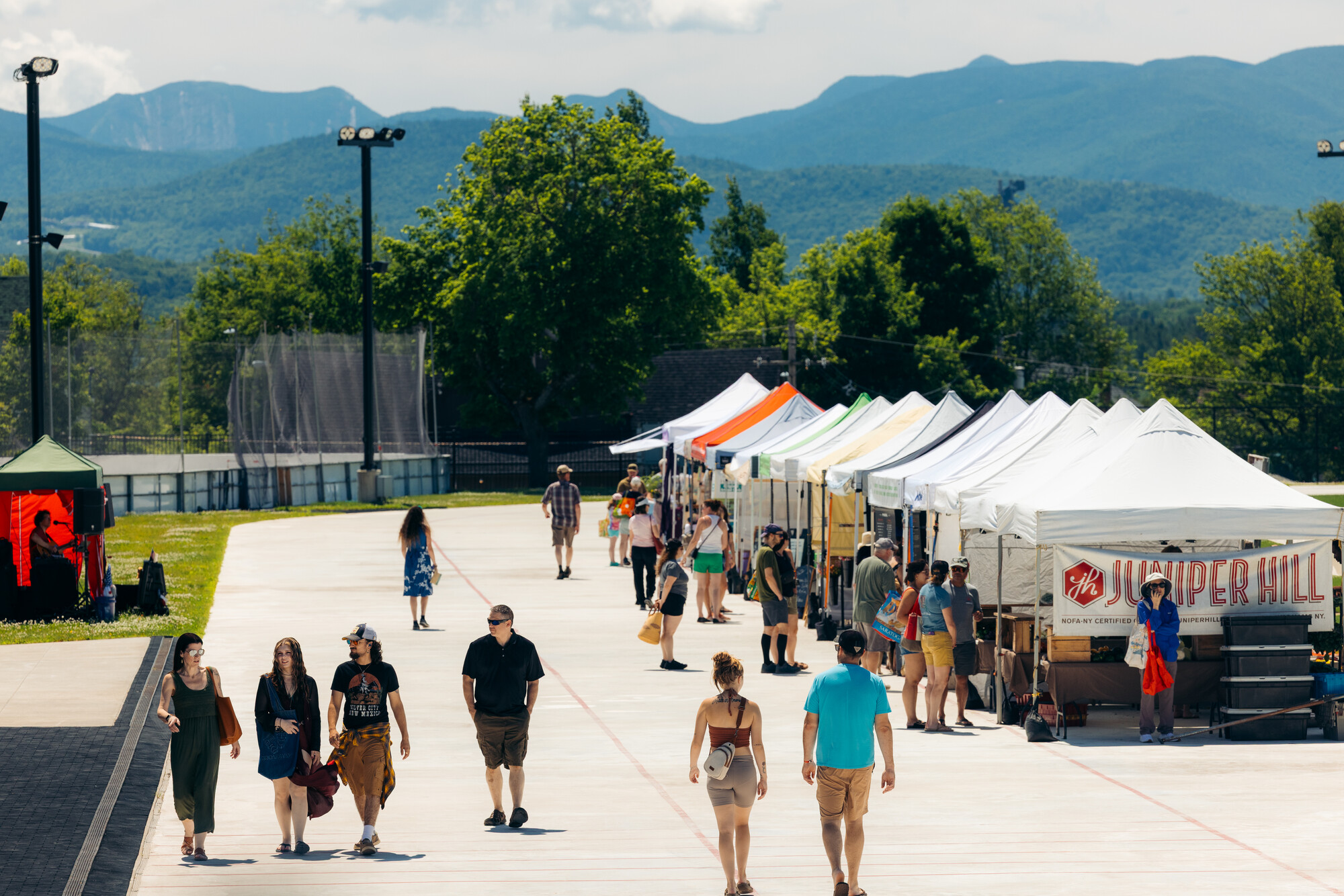 A farmer's market on an outdoor ice rink with no ice 