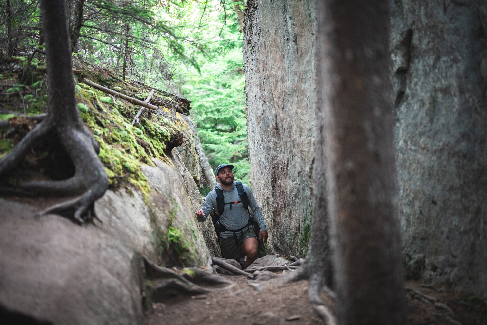 A hiker in between two large rocks