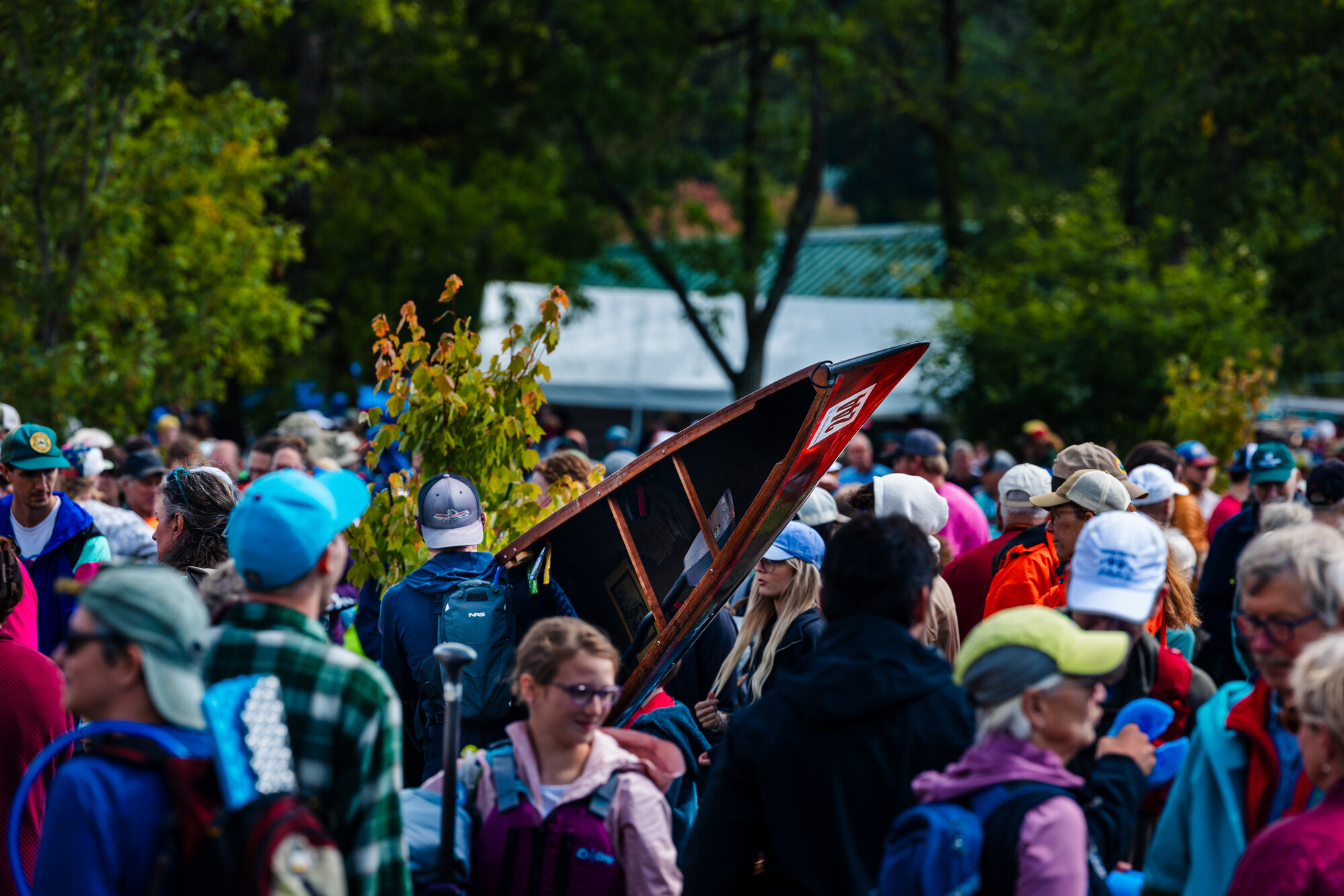 Someone carrying a canoe at a paddling event