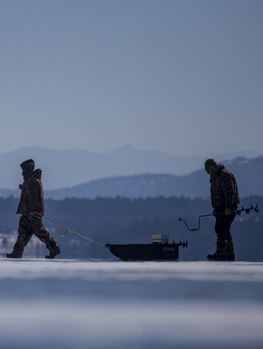 Two people ice fishing Lake Champlain