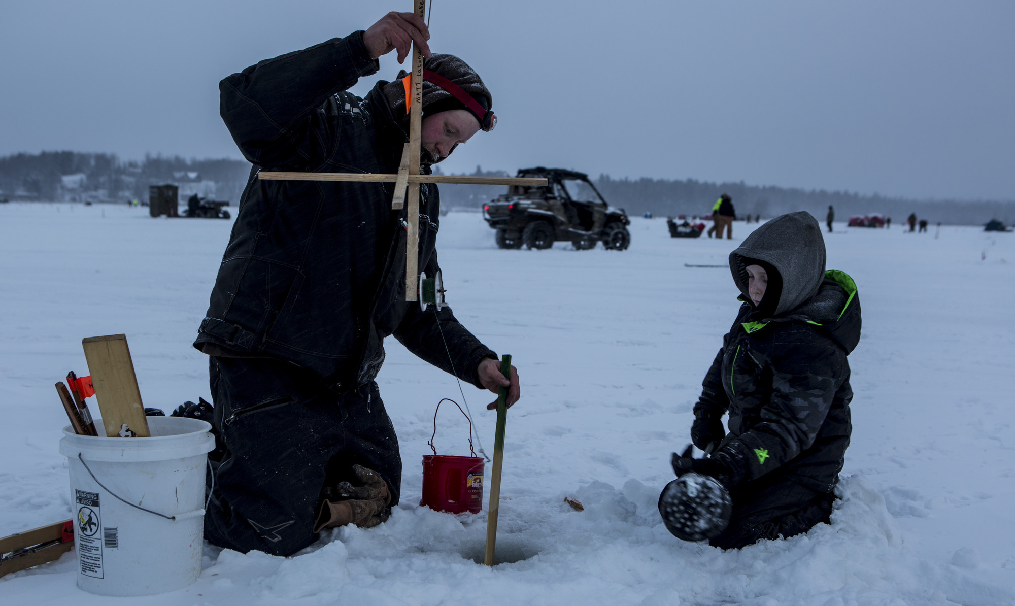 A father and son ice fishing