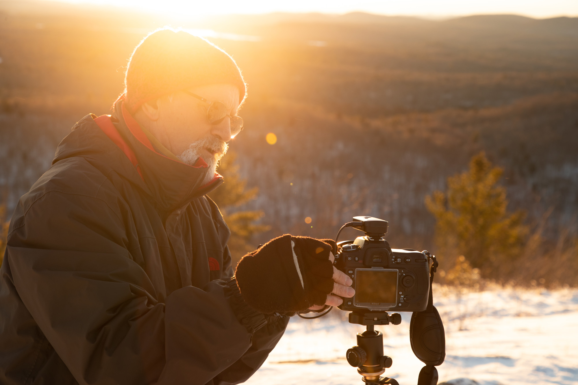 A man with a camera in the winter