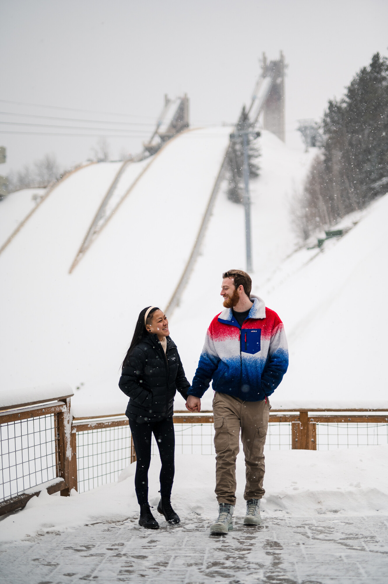 A couple in front of the ski jumps