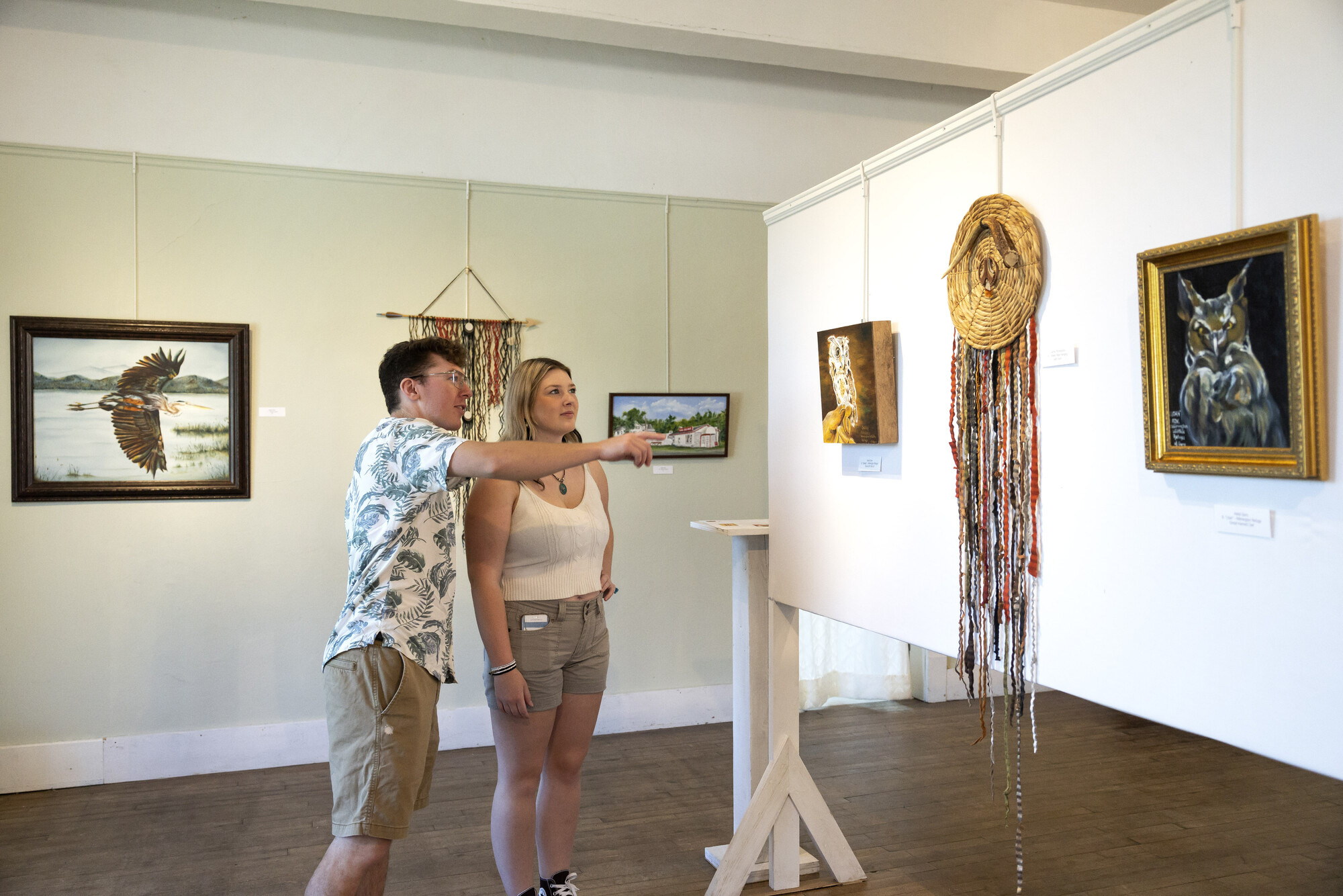 Two people at an art gallery