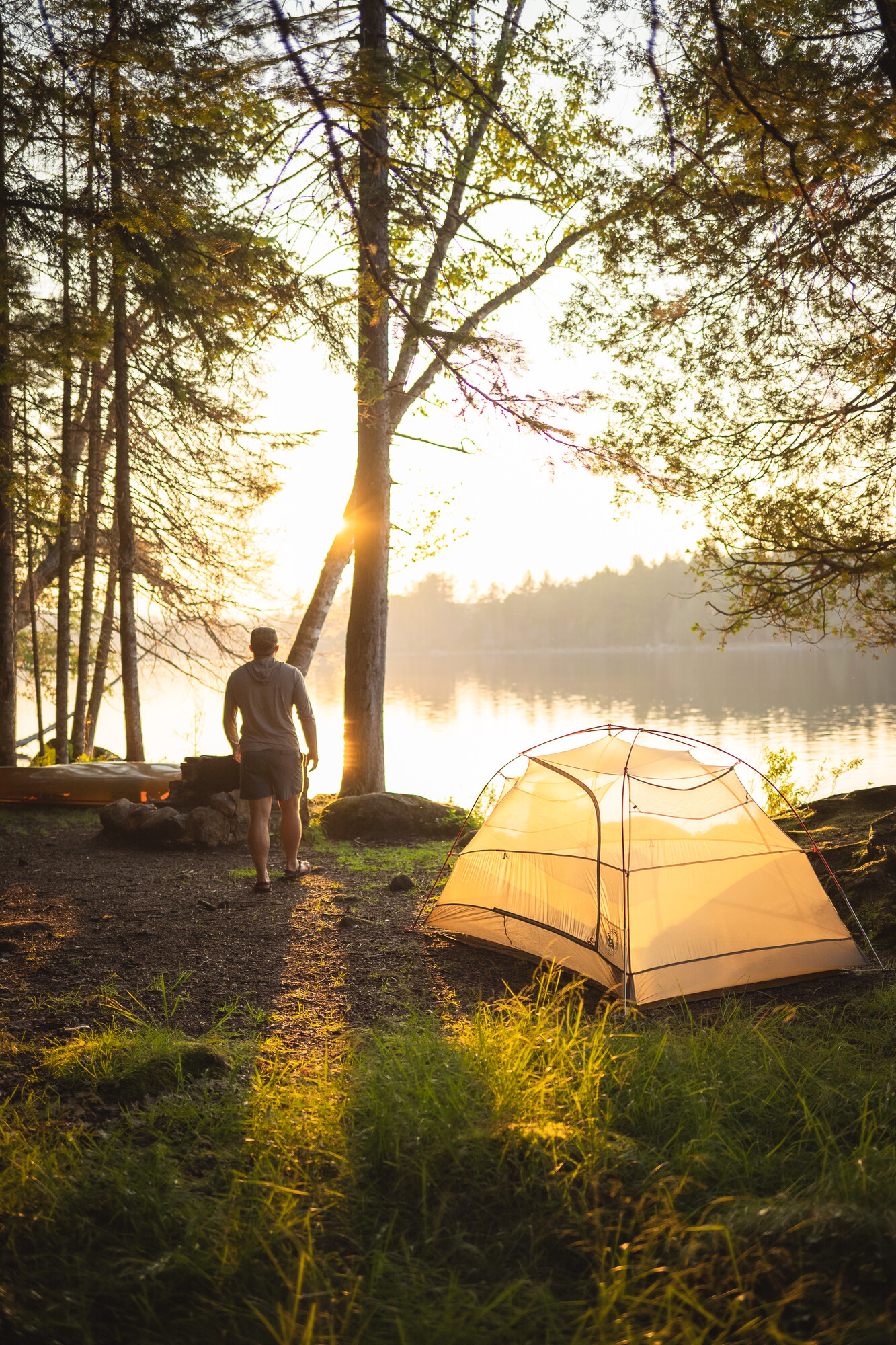 A camper by his tent in the morning