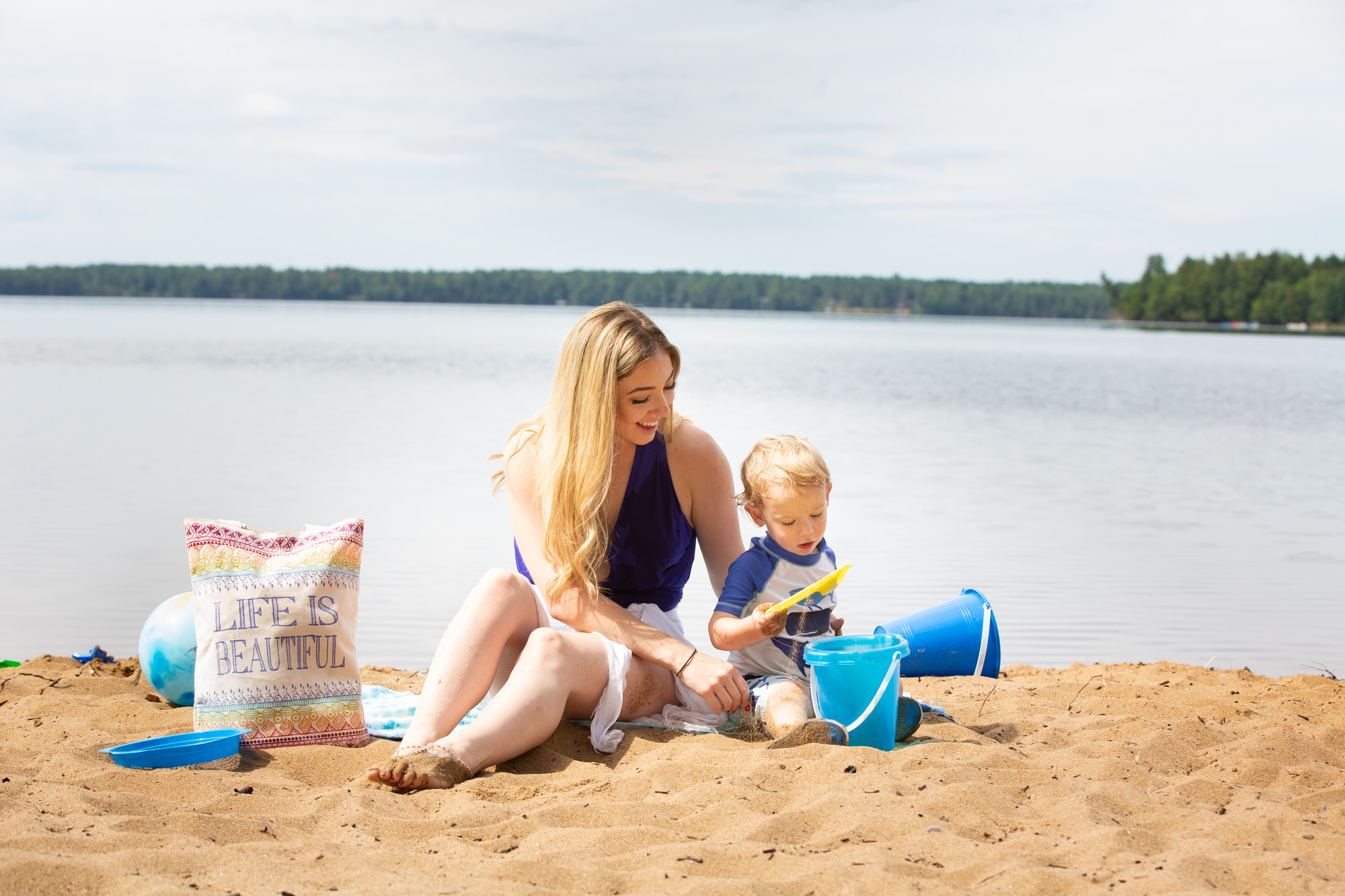 A mother and her young kid at the beach