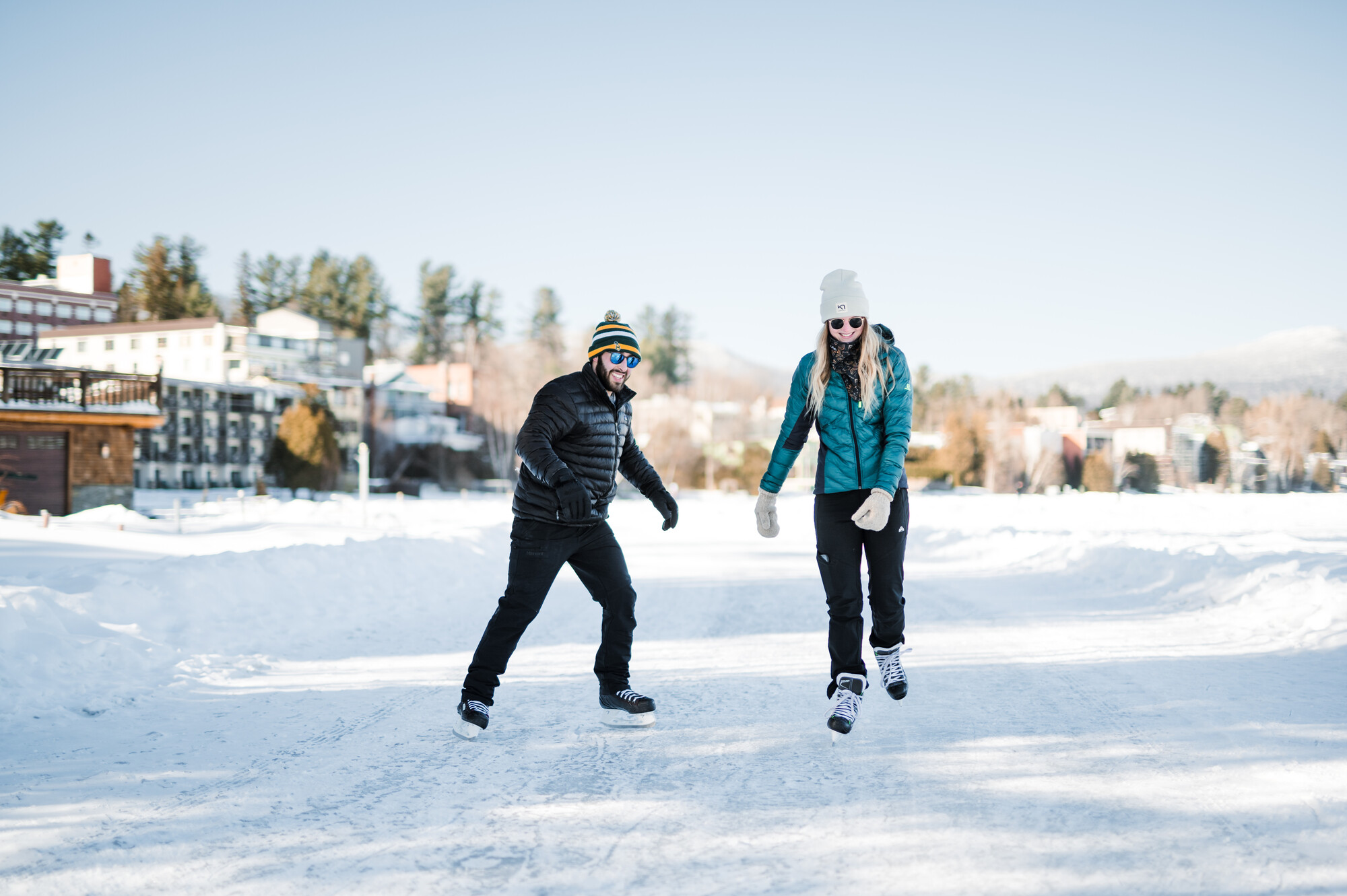 Two people ice skating on a frozen lake
