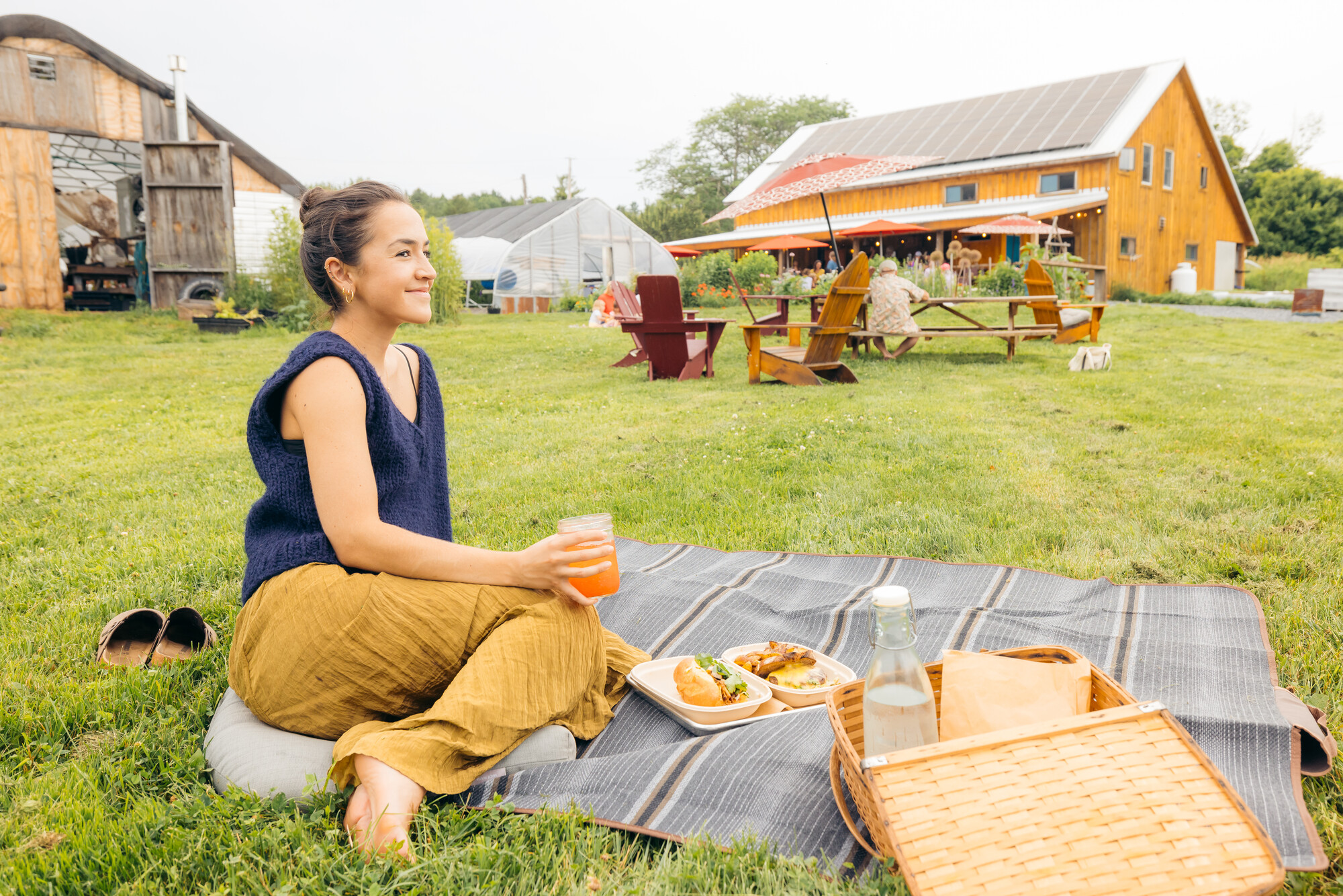 A woman smiling on a picnic blanket