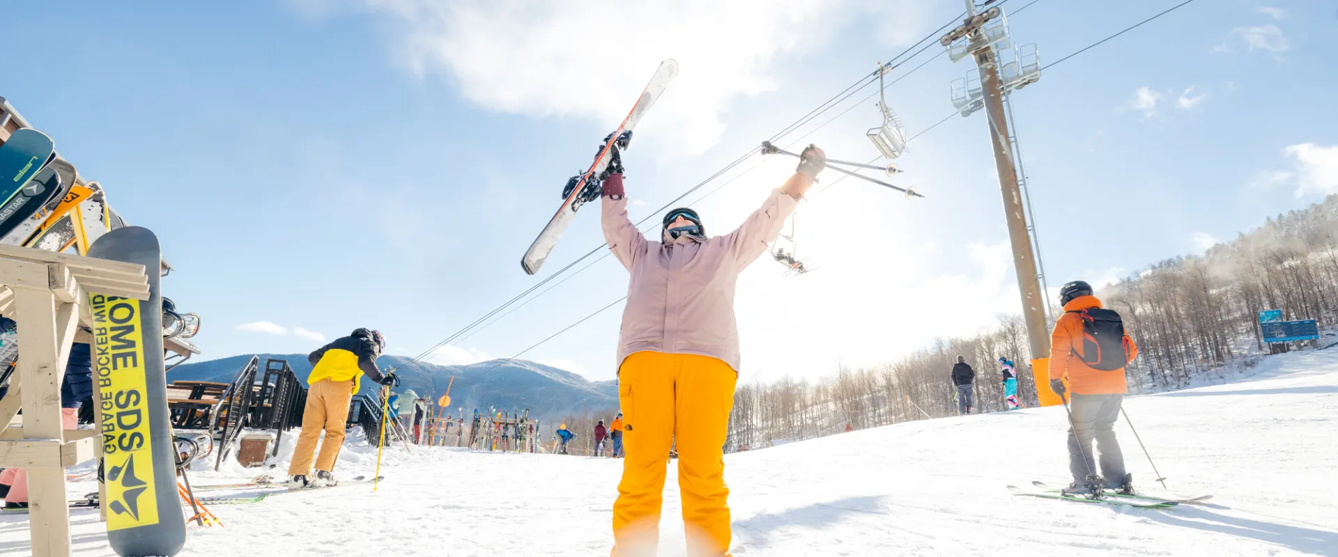 A skier with her hands in the air
