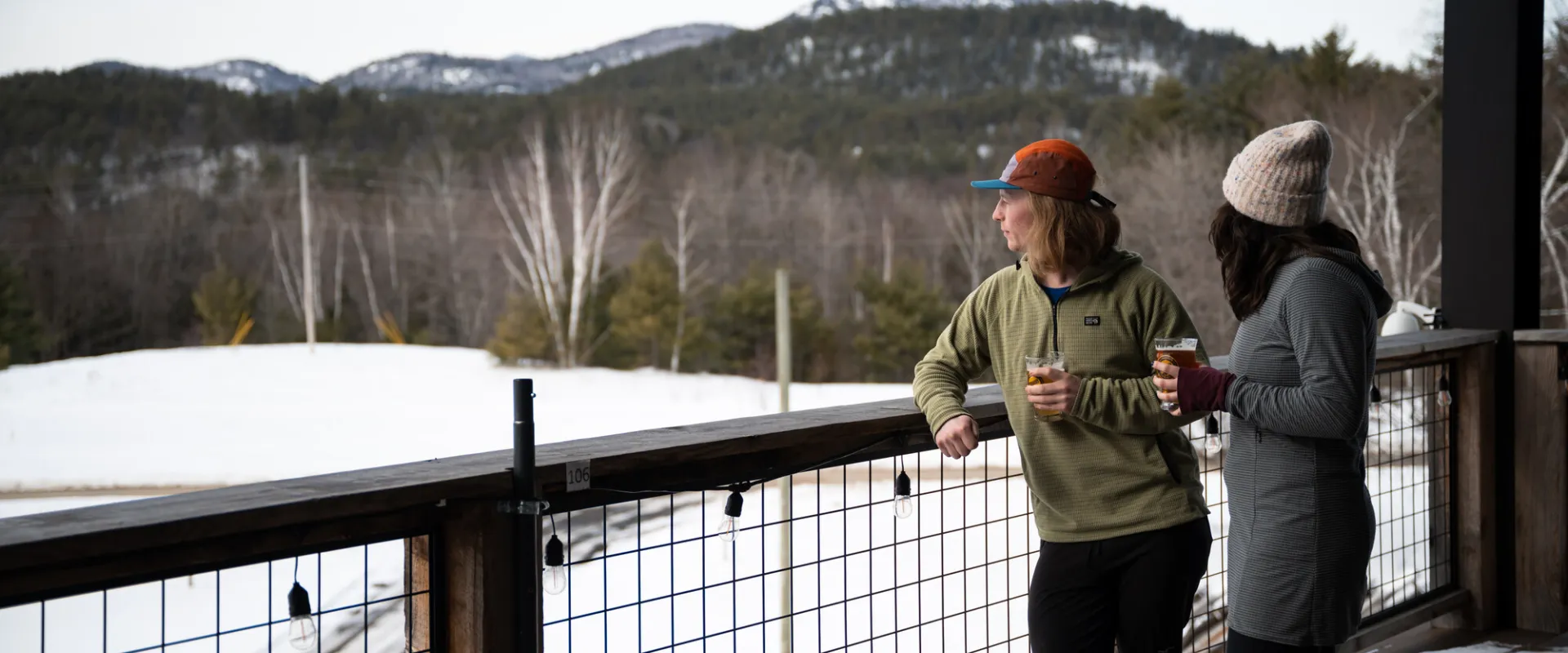 Two people drinking at Paradox Brewery in North Hudson during winter.