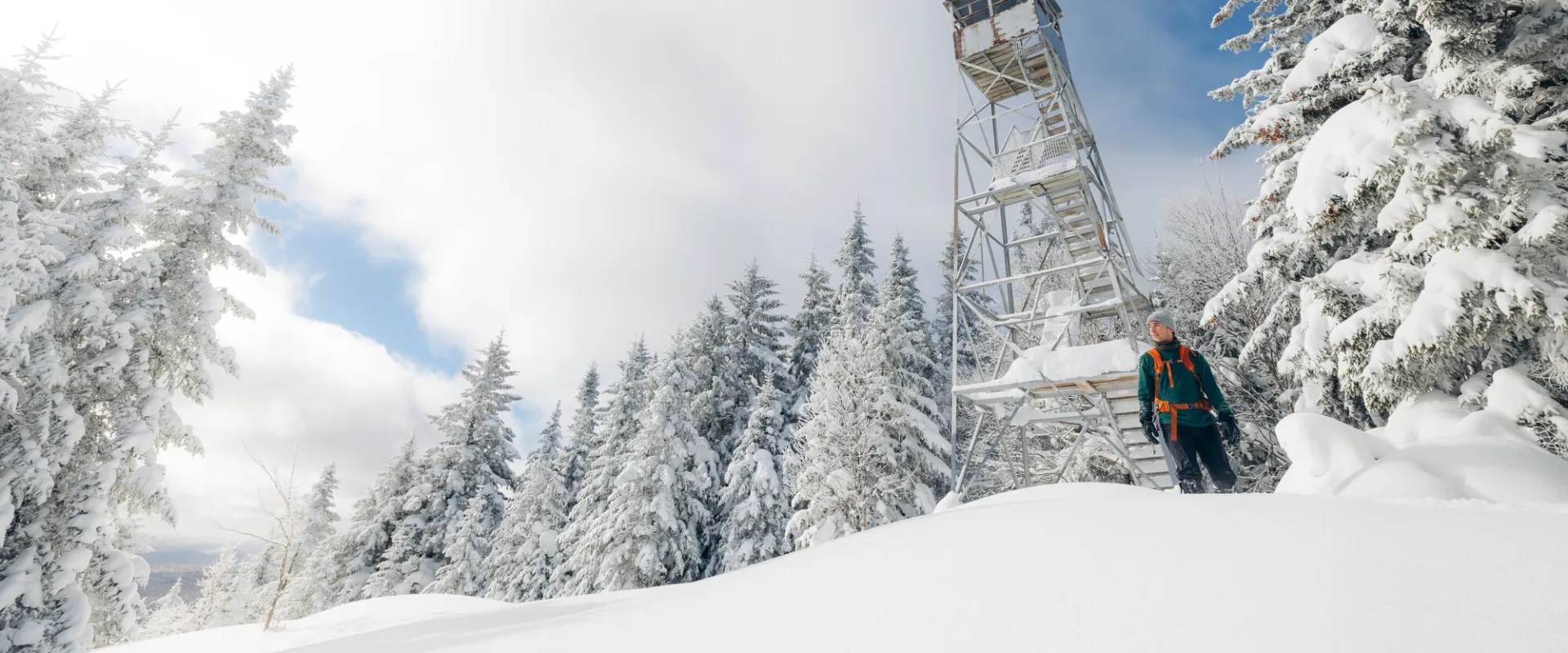A snowshoer near a firetower