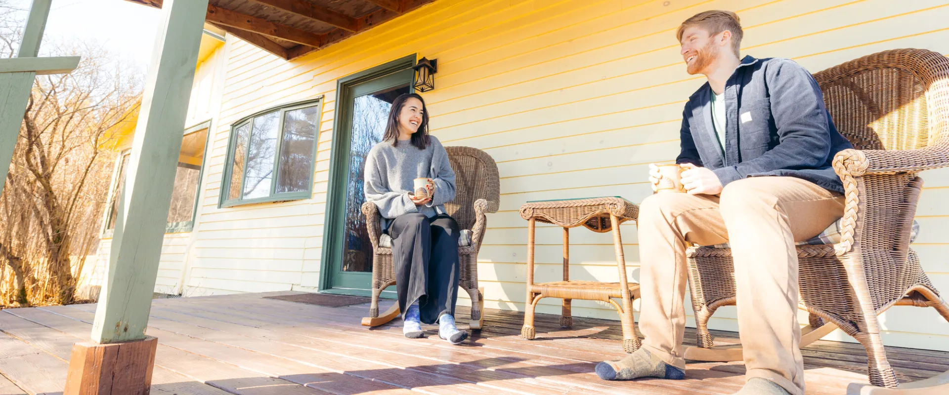 A couple drinking coffee on a porch