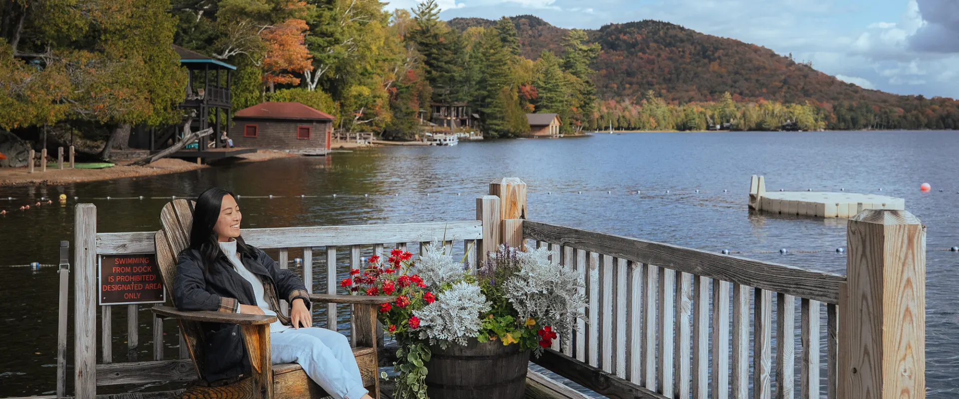 A woman sitting solo on a waterfront deck