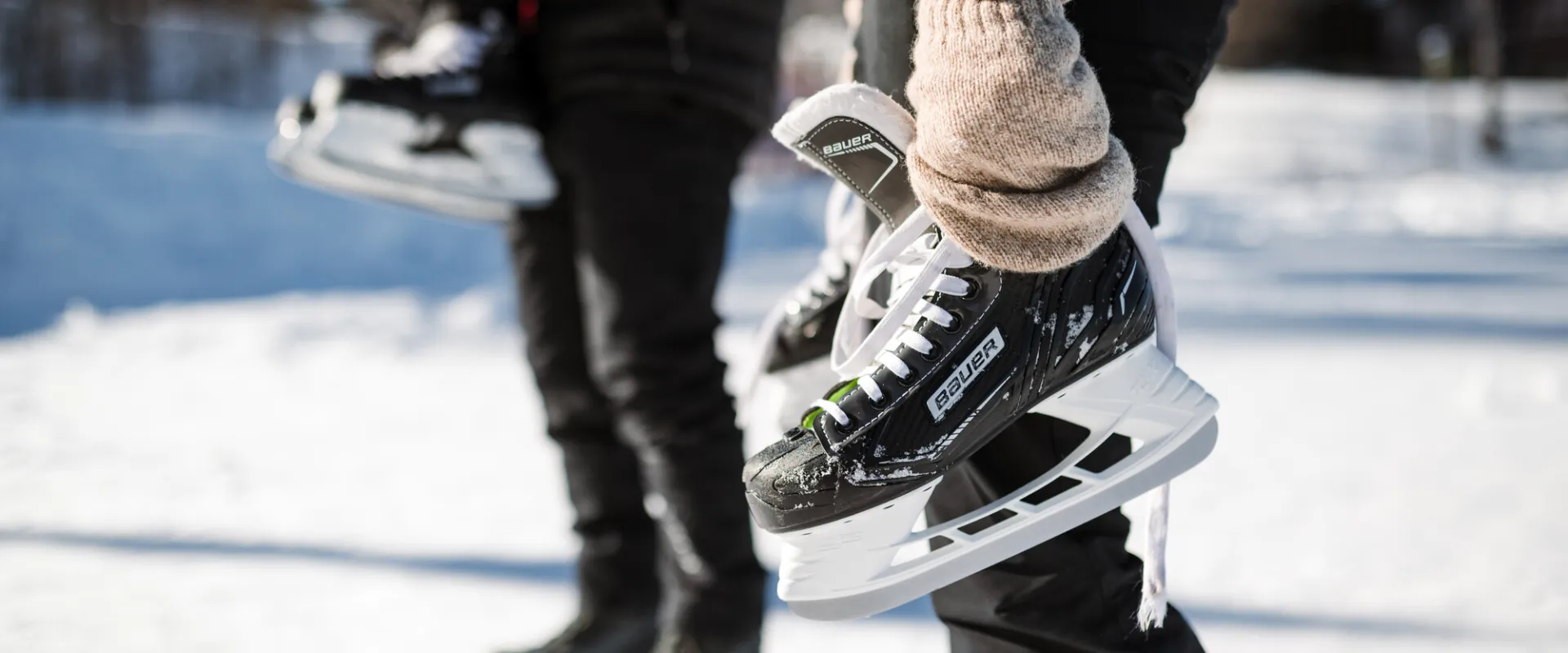 Two people holding ice skates