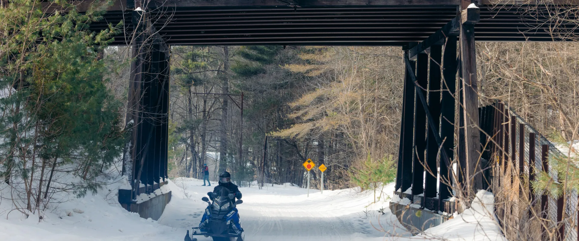 Snowmobile going under bridge