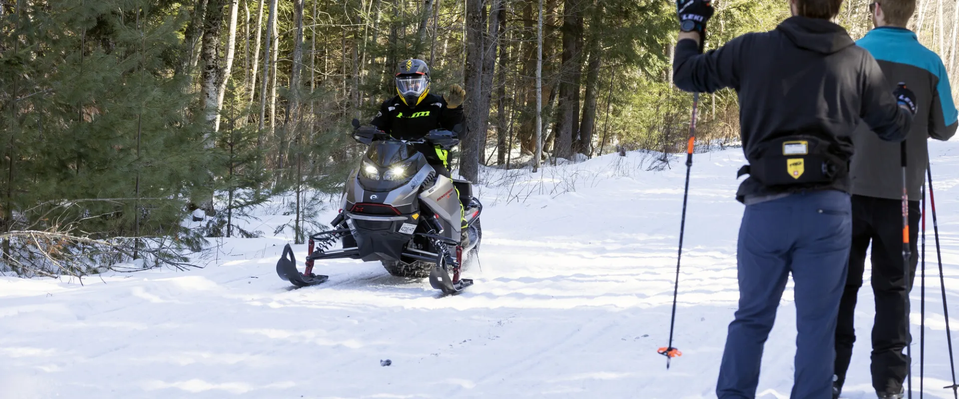 Cross-country skiers passing a snowmobiler on the Rail Trail.