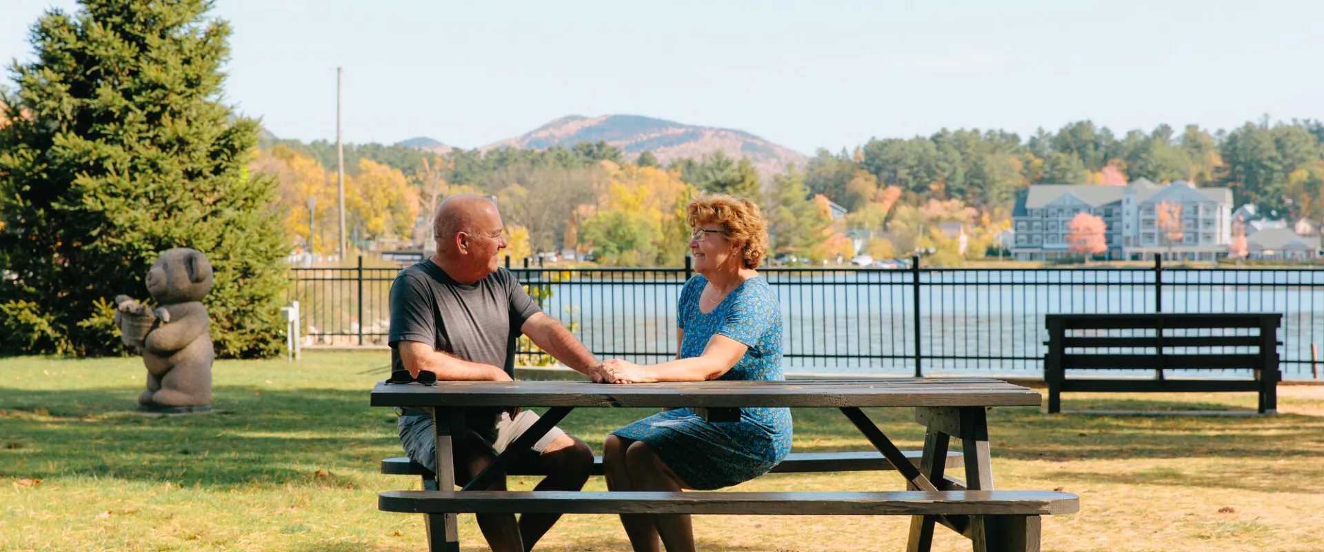 A couple in the park in the fall.