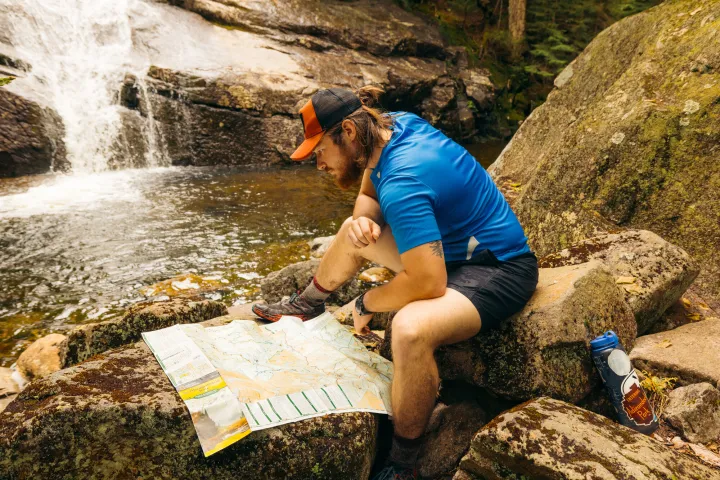 A hiker looking at a map.