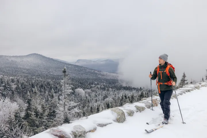 A skier on a toll road in the winter