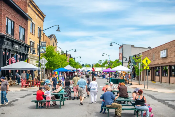 A closed street with people for an event in Tupper Lake