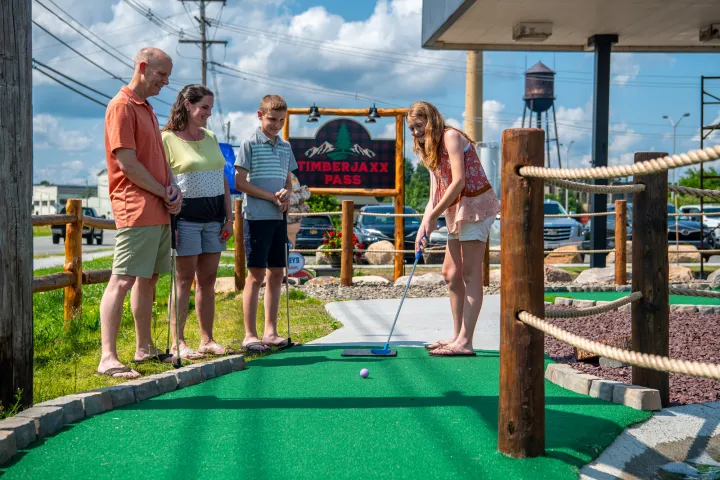 A family playing mini putt