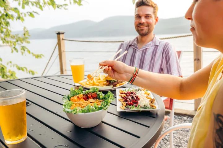 A couple dining lakeside