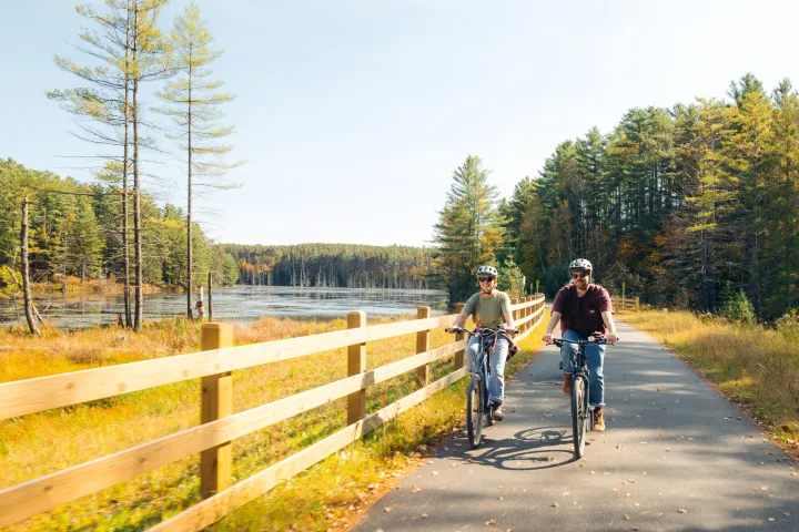 Couples biking on the rail trail in Saranac Lake