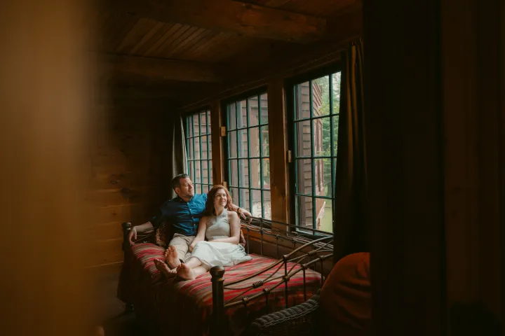A couple on a bed at the Whiteface Lodge