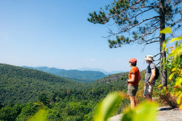 A couple looking out from a hiking viewpoint
