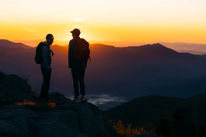 Two people on Cascade Mountain during sunrise