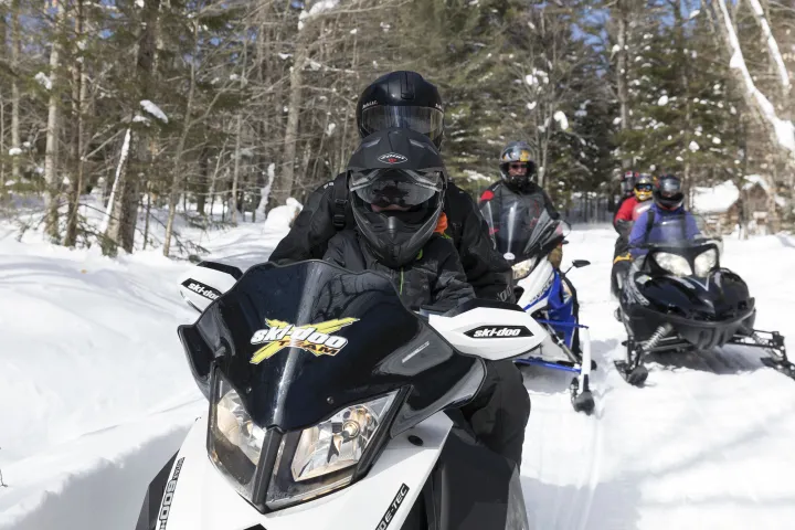 A family snowmobiling