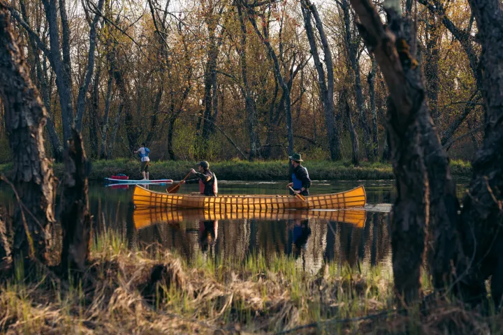 Two people paddling in a pack canoe