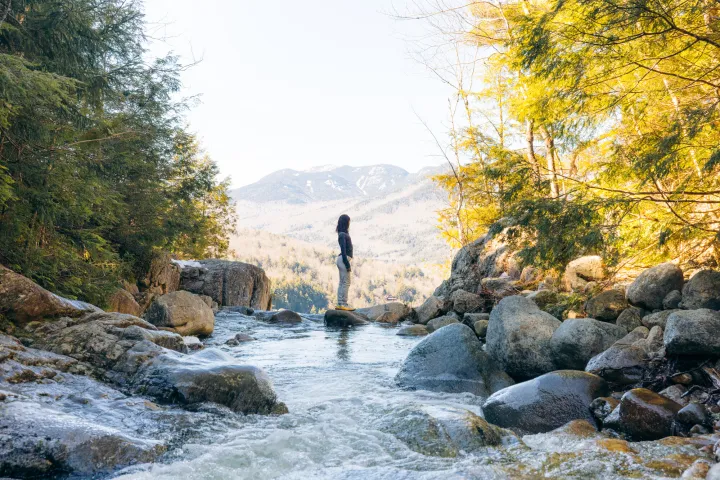 A women standing atop a waterfall
