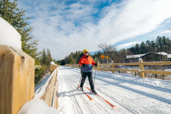 A xc skier on a rail trail
