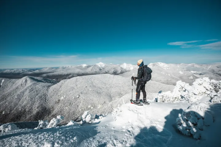 A snowshoer on a very high winter summit