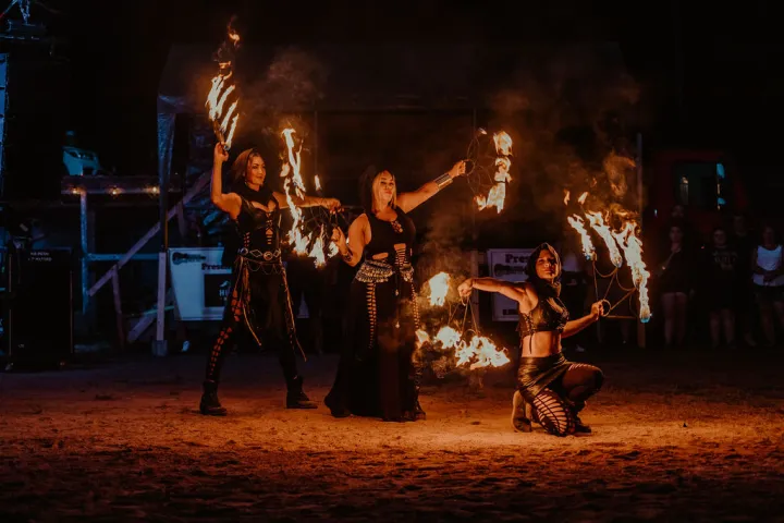 Three people doing a fire act
