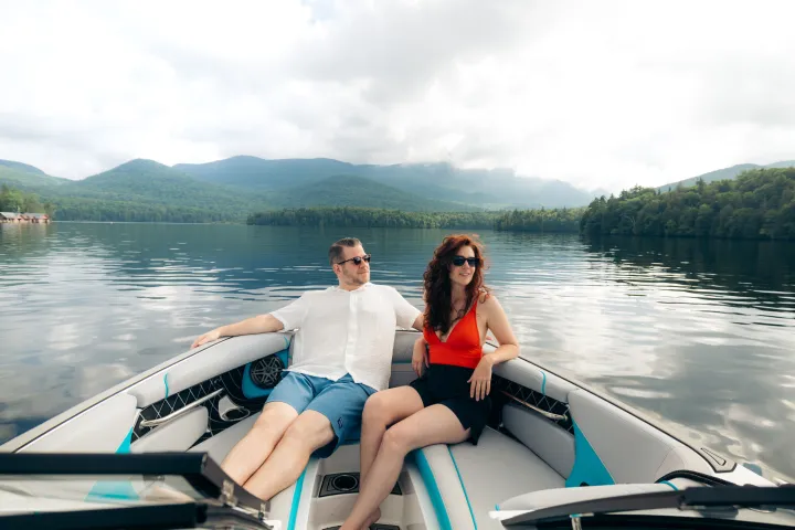 Two people in a motor boat on Lake Placid